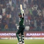 Pakistan’s batter Babar Azam raises his bat to acknowledge the crowd after completing his fifty during waving bat after completed fiffty during the third T20 international cricket match between Pakistan and South Africa at the Gaddafi Stadium.