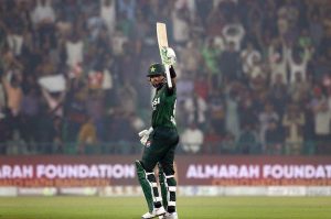 Pakistan’s batter Babar Azam raises his bat to acknowledge the crowd after completing his fifty during waving bat after completed fiffty during the third T20 international cricket match between Pakistan and South Africa at the Gaddafi Stadium.