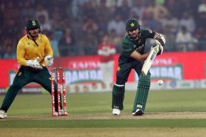 Pakistan’s batter Babar Azam raises his bat to acknowledge the crowd after completing his fifty during waving bat after completed fiffty during the third T20 international cricket match between Pakistan and South Africa at the Gaddafi Stadium.