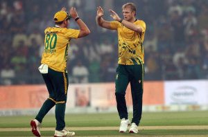 Pakistan’s batter Babar Azam raises his bat to acknowledge the crowd after completing his fifty during waving bat after completed fiffty during the third T20 international cricket match between Pakistan and South Africa at the Gaddafi Stadium.