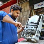 Mechanic busy in repairing instant geyser at his workplace near Khyber Bazar