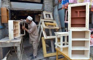 Mechanic busy in repairing instant geyser at his workplace near Khyber Bazar