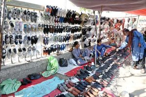 Vendor displaying used shoes to attract the customers at Old Bus Stand Road