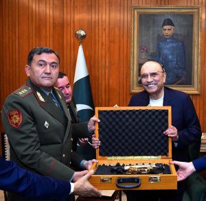 President Asif Ali Zardari presenting a souvenir to Colonel General Sabirzoda Emomali Abdulrahim, Defence Minister of Tajikistan, at Aiwan-e-Sadr.