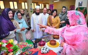 Mayor of Peshawar Zubair Ali and VC SBBWU Prof. Dr. Safia Ahmed (T.I), along with other officials and organizers, visit display stalls during the second day of the Dosti Peshawar Women Literature Festival 3rd Edition at City District College.