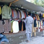As the cold weather sets in, people are seen purchasing jackets and coats from roadside stalls to keep themselves warm