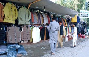 As the cold weather sets in, people are seen purchasing jackets and coats from roadside stalls to keep themselves warm