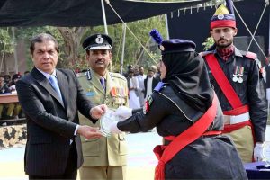 Federal Minister for Railways Muhammad Hanif Abbasi presenting a shield to a policewoman during the passing-out parade of 468 personnel at the Railway Police Training School, Walton