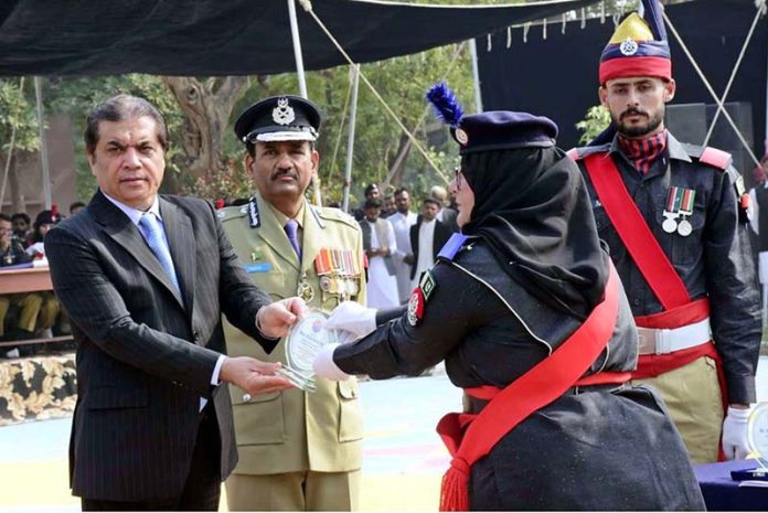 Federal Minister for Railways Muhammad Hanif Abbasi presenting a shield to a policewoman during the passing-out parade of 468 personnel at the Railway Police Training School, Walton