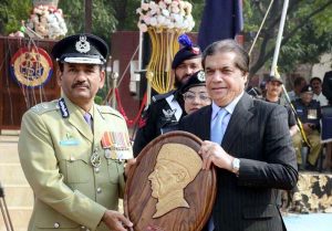 Federal Minister for Railways Muhammad Hanif Abbasi presenting a shield to a policewoman during the passing-out parade of 468 personnel at the Railway Police Training School, Walton