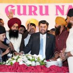 Sindh Governor Kamran Khan Tessori cutting a cake along with participants to celebrate the 556th birth anniversary of Baba Guru Nanak, the spiritual leader of the Sikh community, at the Governor House