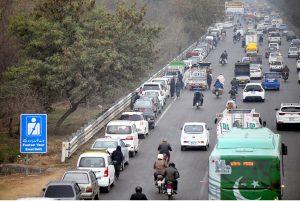 A long queue of commuters waiting for their turn to get M-TAG from a registration center in Kachnar Park in sector I-8.