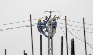 WAPDA workers installing new electrical wires at Kacheri Chowk