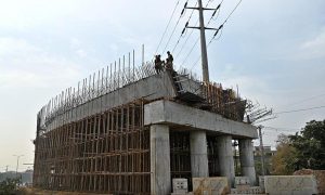 Labourers busy in construction work of flyover at under construction 10th Avenue during development work in Federal Capital