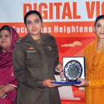 Chairperson Punjab Women Protection Authority, Hina Pervez Butt distributes shields among participants during a ceremony held in connection with the 16 Days of Activism campaign against violence toward women.