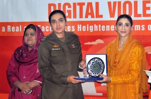 Chairperson Punjab Women Protection Authority, Hina Pervez Butt distributes shields among participants during a ceremony held in connection with the 16 Days of Activism campaign against violence toward women.