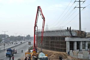 Labourers busy in construction work of flyover at under construction 10th Avenue during development work in Federal Capital