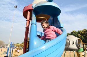 Children enjoy seesaw in F-9 Park during their winter vacation.