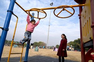 Children enjoy seesaw in F-9 Park during their winter vacation.