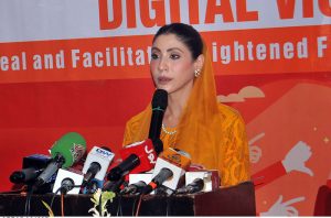 Chairperson Punjab Women Protection Authority, Hina Pervez Butt distributes shields among participants during a ceremony held in connection with the 16 Days of Activism campaign against violence toward women.
