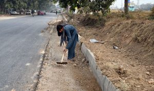 Labourers are busy installing a protection wall along the Faizabad Interchange in the Federal Capital.