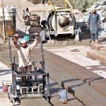 Workers are busy preparing cemented blocks at their workplace