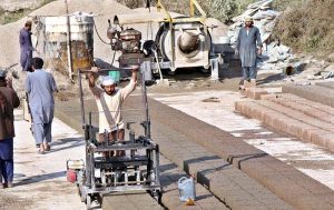 Workers are busy preparing cemented blocks at their workplace