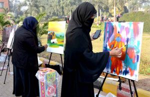 Students participate in a painting competition during the Art Gala exhibition at the Expo Centre, University of Agriculture Faisalabad.