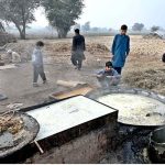 A worker preparing jaggery "Gurr" from sugarcane juice at his roadside stall, preserving a cherished traditional wintertime practice.