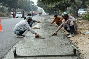Labourers are busy installing a protection wall along the Faizabad Interchange in the Federal Capital.