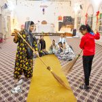 Christian girls engaged in cleanup activities at St. Joseph’s Church in preparation for Christmas.