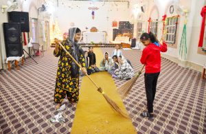 Christian girls engaged in cleanup activities at St. Joseph’s Church in preparation for Christmas.