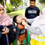 A lady health worker administers polio drops to a child during the Anti-Polio Vaccination Campaign at Paretabad Hospital.