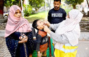 A lady health worker administers polio drops to a child during the Anti-Polio Vaccination Campaign at Paretabad Hospital.
