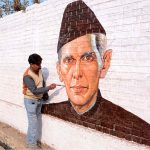 An artist puts the final touches on a portrait of Quaid-e-Azam Muhammad Ali Jinnah on wall ahead of his death anniversary.