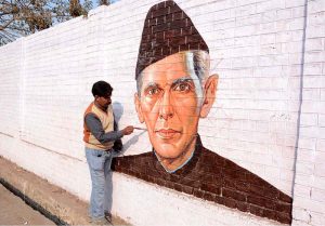 An artist puts the final touches on a portrait of Quaid-e-Azam Muhammad Ali Jinnah on wall ahead of his death anniversary.