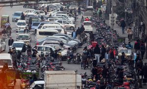A road is blocked due to vehicles wrongly parked in a no-parking zone, disrupting traffic flow and pedestrian movement. Authorities are urged to take notice to prevent further inconvenience