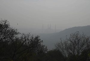 The iconic Faisal Mosque fades from view as a thick blanket of winter fog engulfs the federal capital.