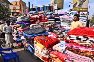 A vendor displaying blanket to attract the customer at Bacha Khan Chowk.