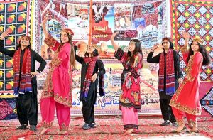 Students performing in a tableau during a function in connection with the upcoming Sindhi Ajrak Topi Culture Day at Government Girls Degree College.