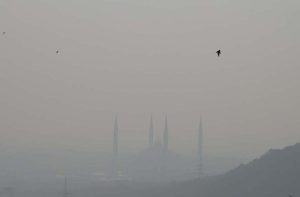 The iconic Faisal Mosque fades from view as a thick blanket of winter fog engulfs the federal capital.