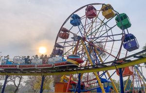 Children enjoy a train ride at Lake View Park as golden sunlight breaks through clouds over the federal capital.