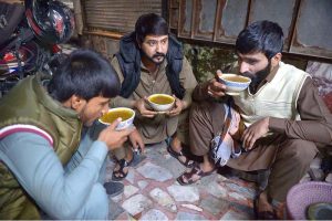 People enjoy the traditional winter drink “Yakhni” in the Hashtnagri area.