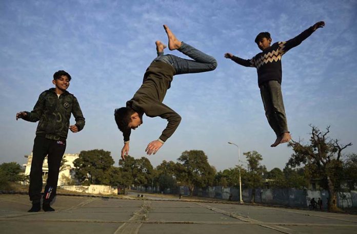 Youngsters leap and play with energy, creating striking silhouettes during the afternoon at G-6 in the Federal Capital