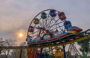 Children enjoy a train ride at Lake View Park as golden sunlight breaks through clouds over the federal capital.