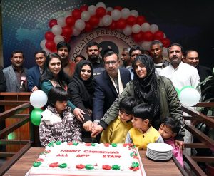Managing Director Associated Press of Pakistan Muhammad Asim Khichi cutting a Christmas cake with APP staff at the APP Headquarters.
