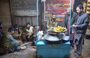 People enjoy the traditional winter drink “Yakhni” in the Hashtnagri area.