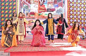 Students performing in a tableau during a function in connection with the upcoming Sindhi Ajrak Topi Culture Day at Government Girls Degree College.