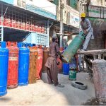 Labourers are busy unloading gas cylinder from delivery truck at shop in Ghouri Town