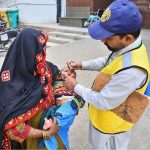 Health worker administering polio drops to a child during Anti-Polio Vaccination Campaign at Shah Bhitai Hospital